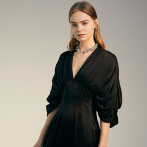 The front of a model wearing a black Bat Sleeve Dress