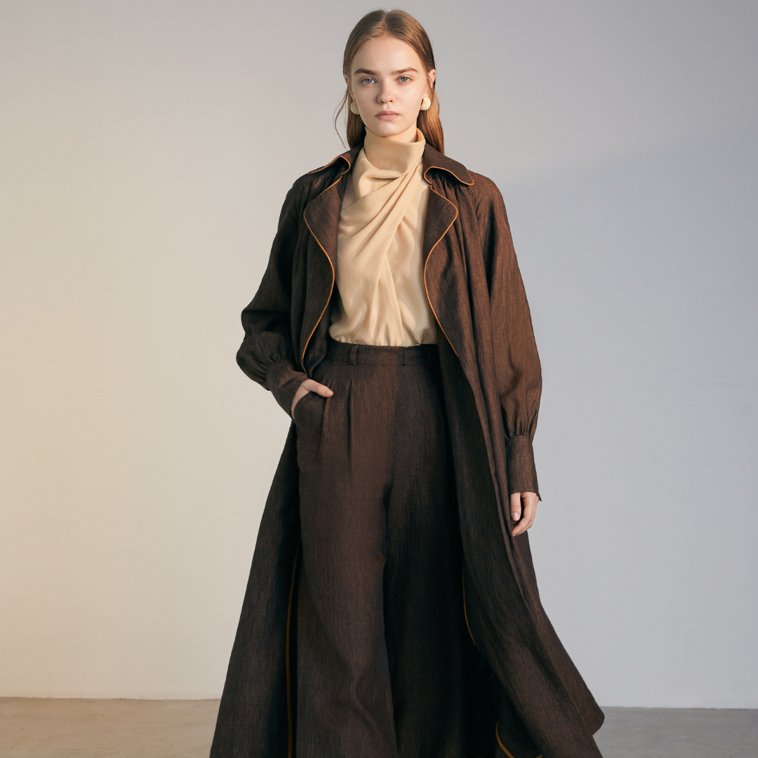 The front of a model wearing a brown colored Long Coat