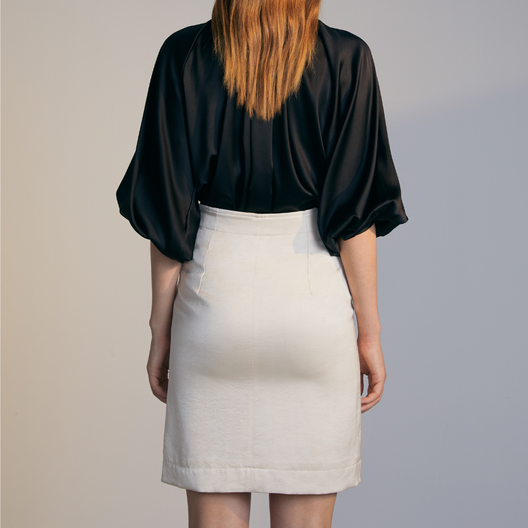 The back of a model wearing a white Short Skirt