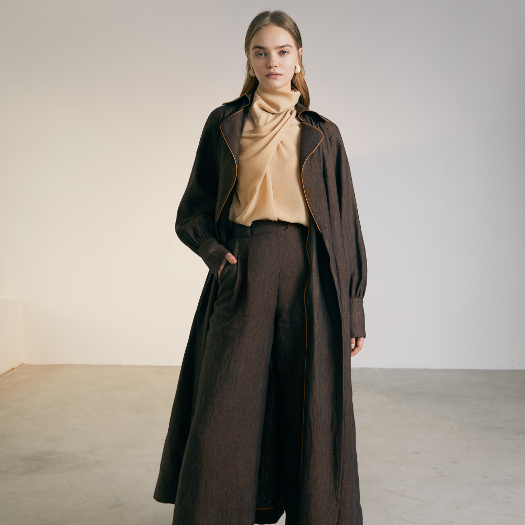 The front of a model wearing a brown colored Long Coat