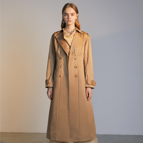 The front of a model wearing a beige colored Trench Coat