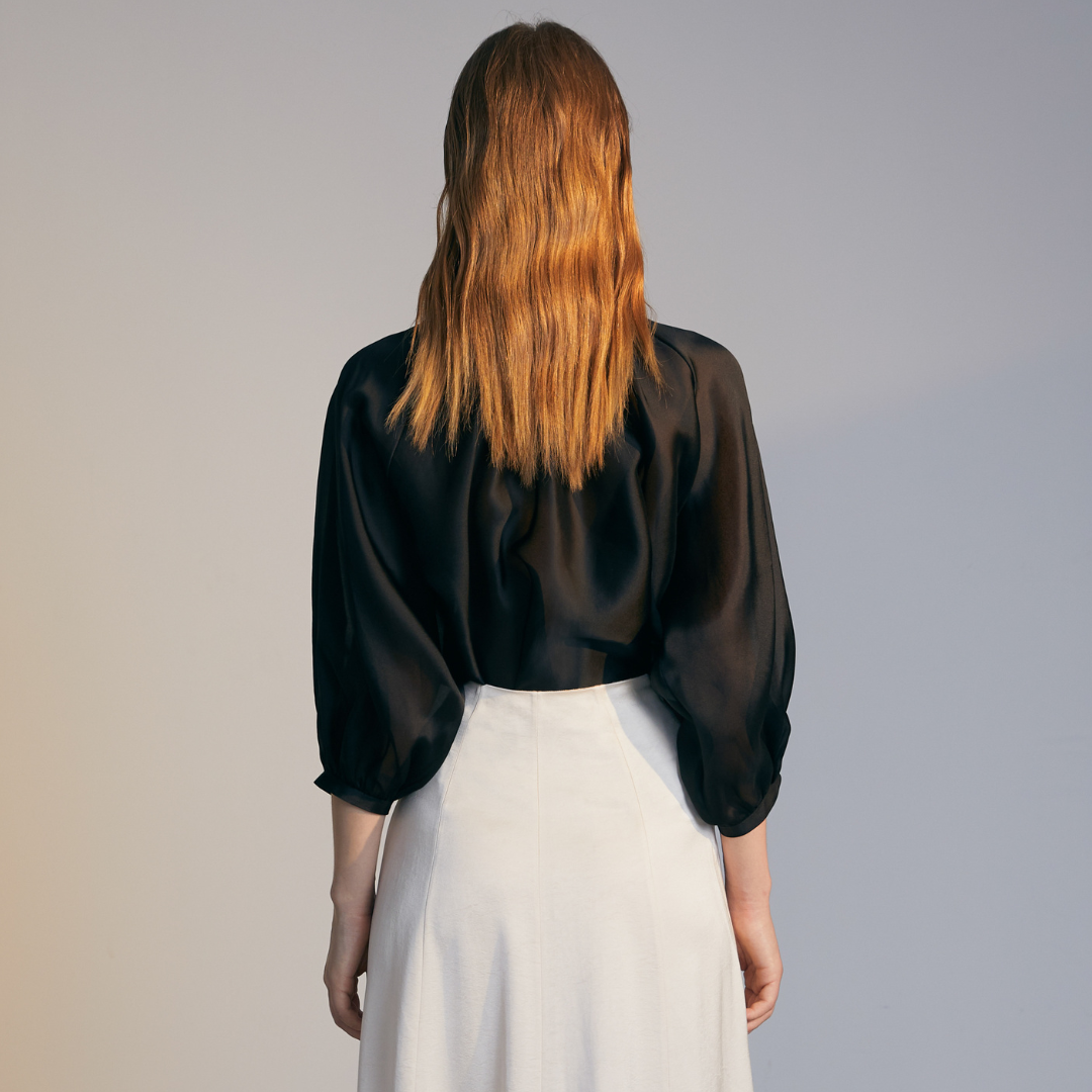 The back of a model wearing a black Organza Shirt