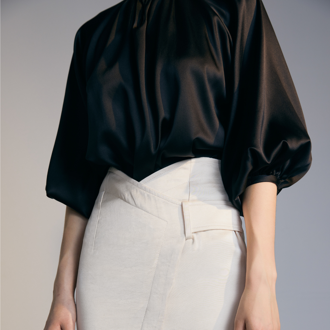 Close-up of the front of a model wearing a black Silk Shirt