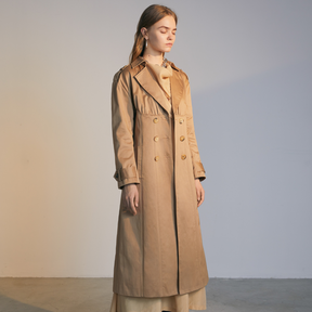 The front of a model wearing a beige colored Trench Coat