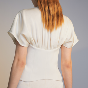 The back of a model wearing a white Belted Top
