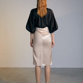 The back of a model wearing an ivory colored Twisted Skirt