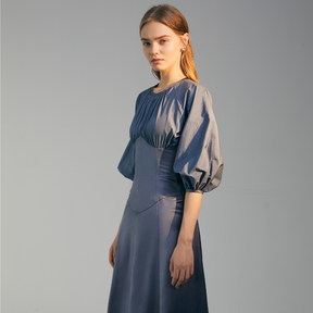The side of a model wearing a blue Gigot Sleeve Dress