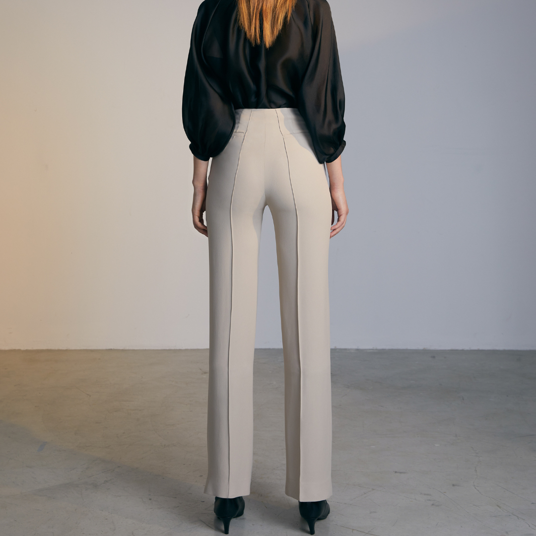 The back of A model wearing Natural colored Asymmetrical Belt Pants