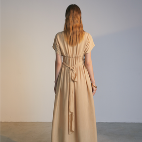The back of a model wearing a natural colored Knotted Dress