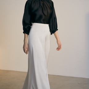 The side of a model wearing a white full Skirt