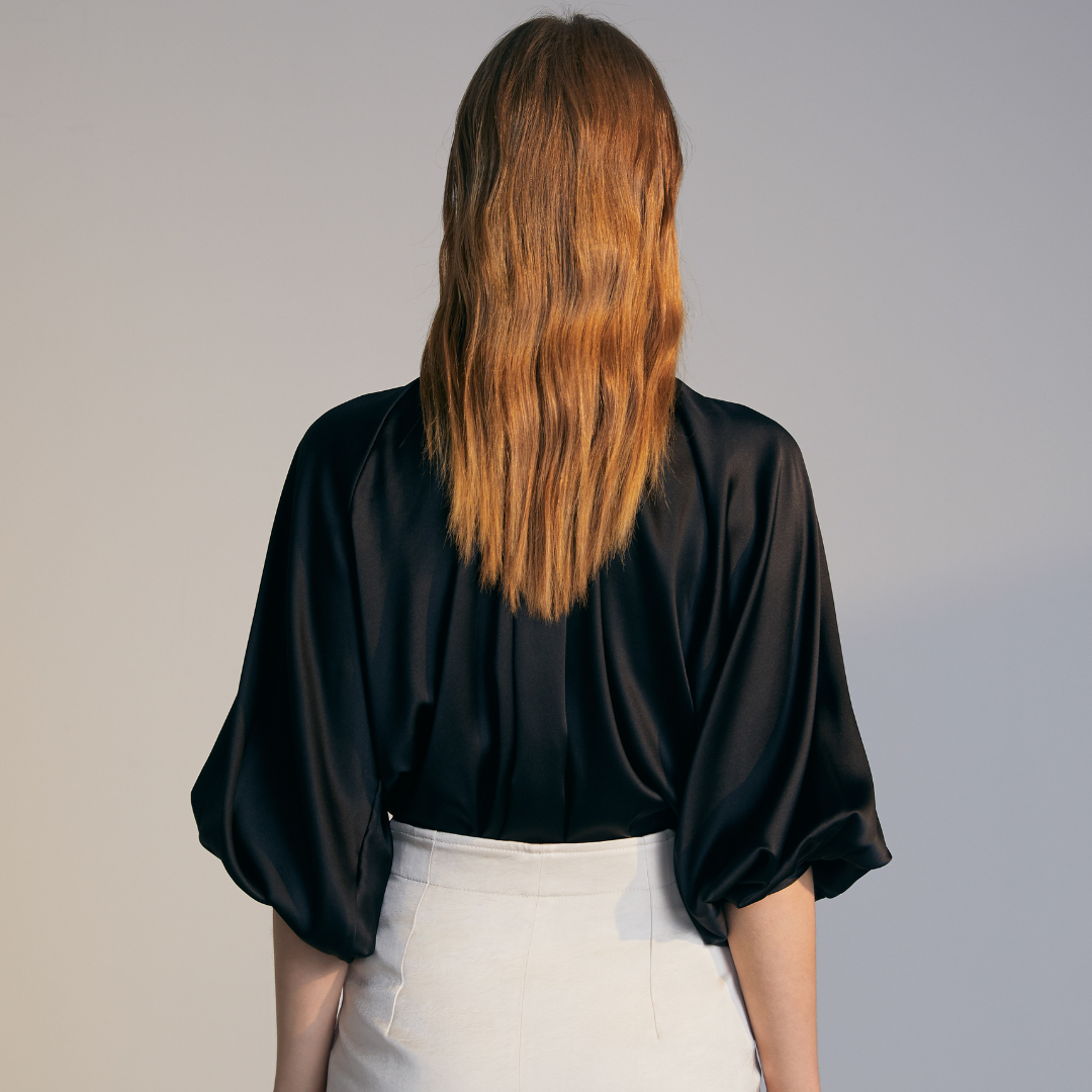 The back of a model wearing a black Silk Shirt