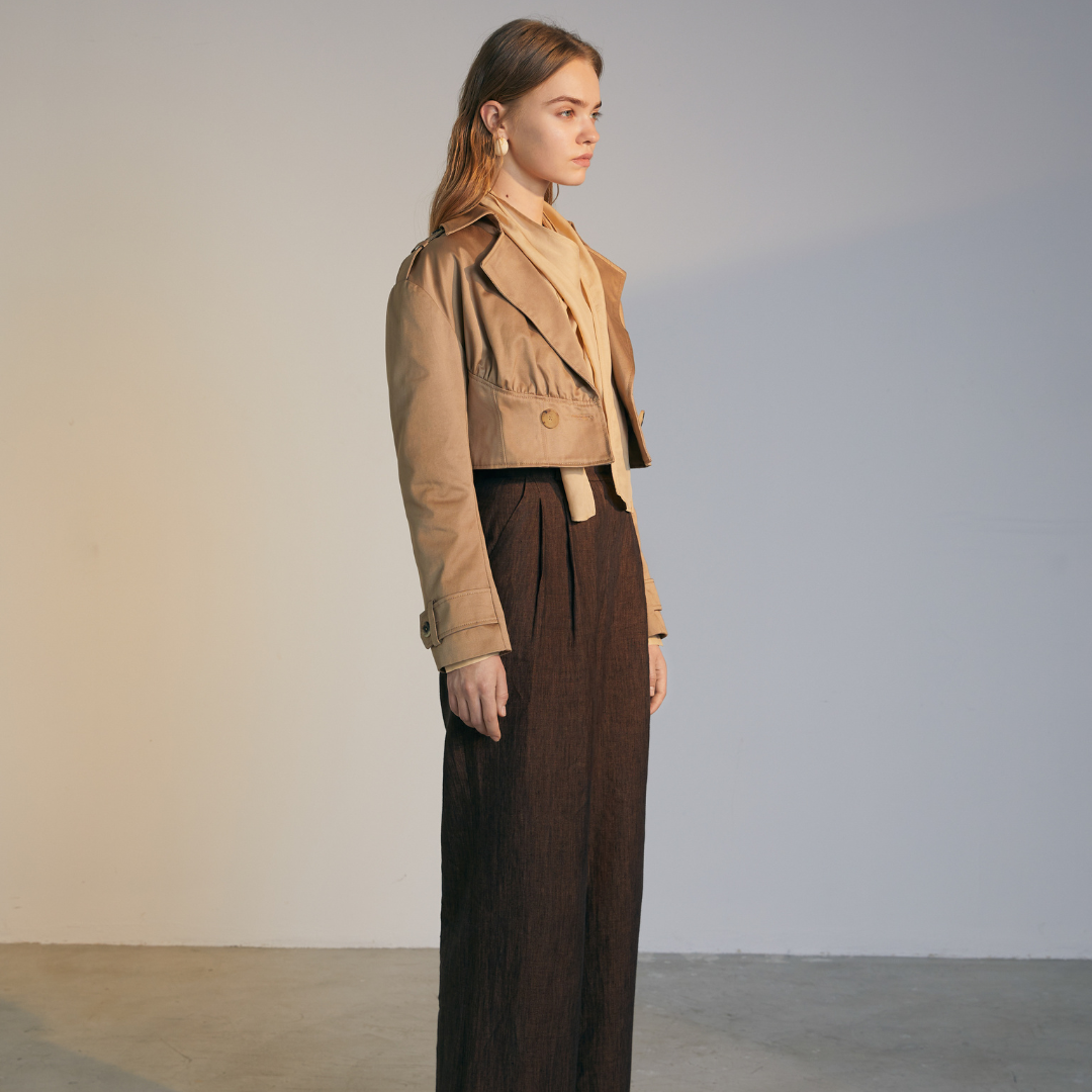 The side of a model wearing a light brown Short Trench Coat
