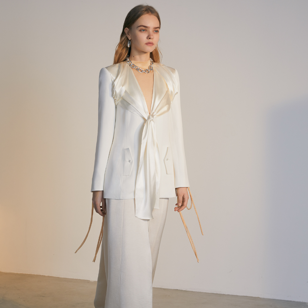 The front of a model wearing a white Knotted Suit Jacket