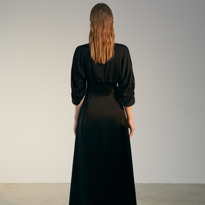 The back of  a model wearing a black Bat Sleeve Dress