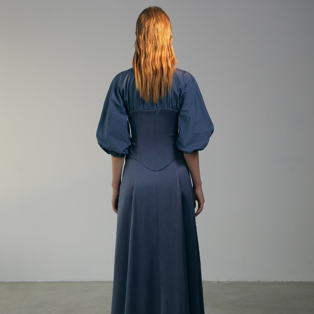 The back of a model wearing a blue Gigot Sleeve Dress