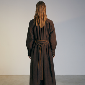 The back of a model wearing a brown colored Long Coat