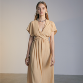 The front of a model wearing a natural colored Knotted Dress